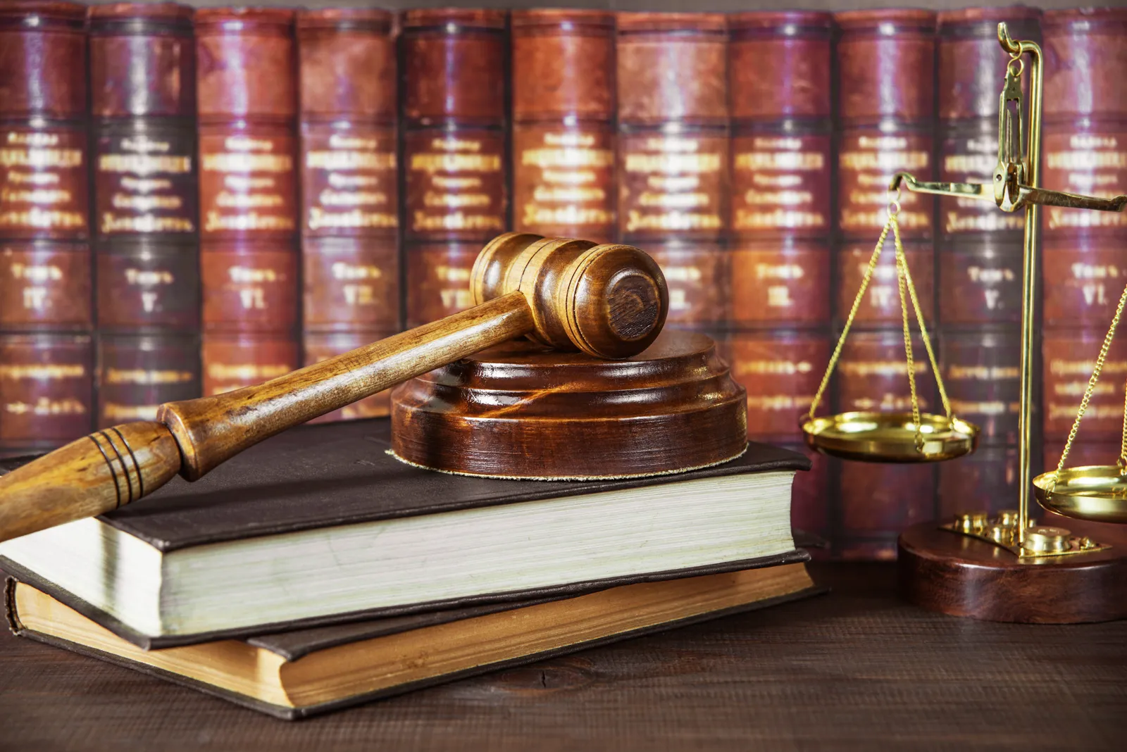 Judge's gavel, scales of justice, and law books